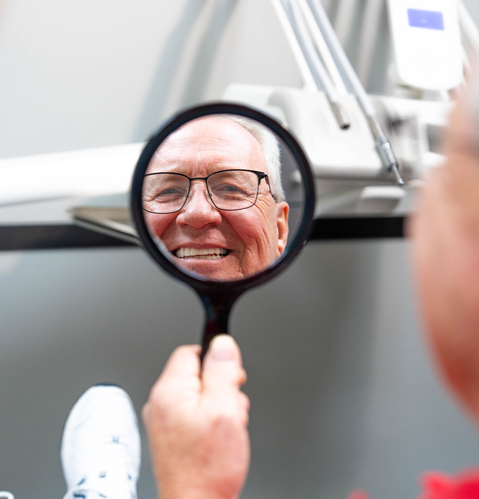 Patient smiling brightly after their dental procedure