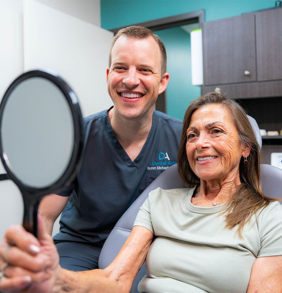 patient and doctor both smiling brightly after patient's dental procedure