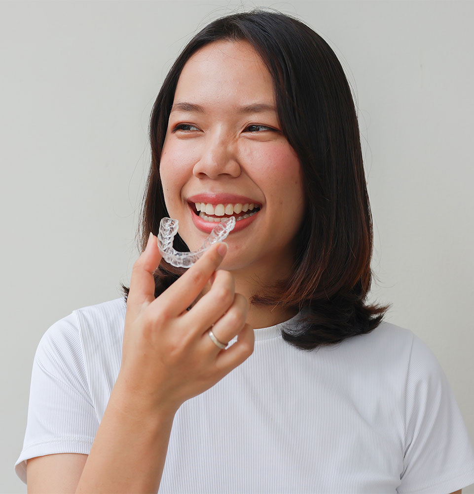 close up of person applying their clear aligners