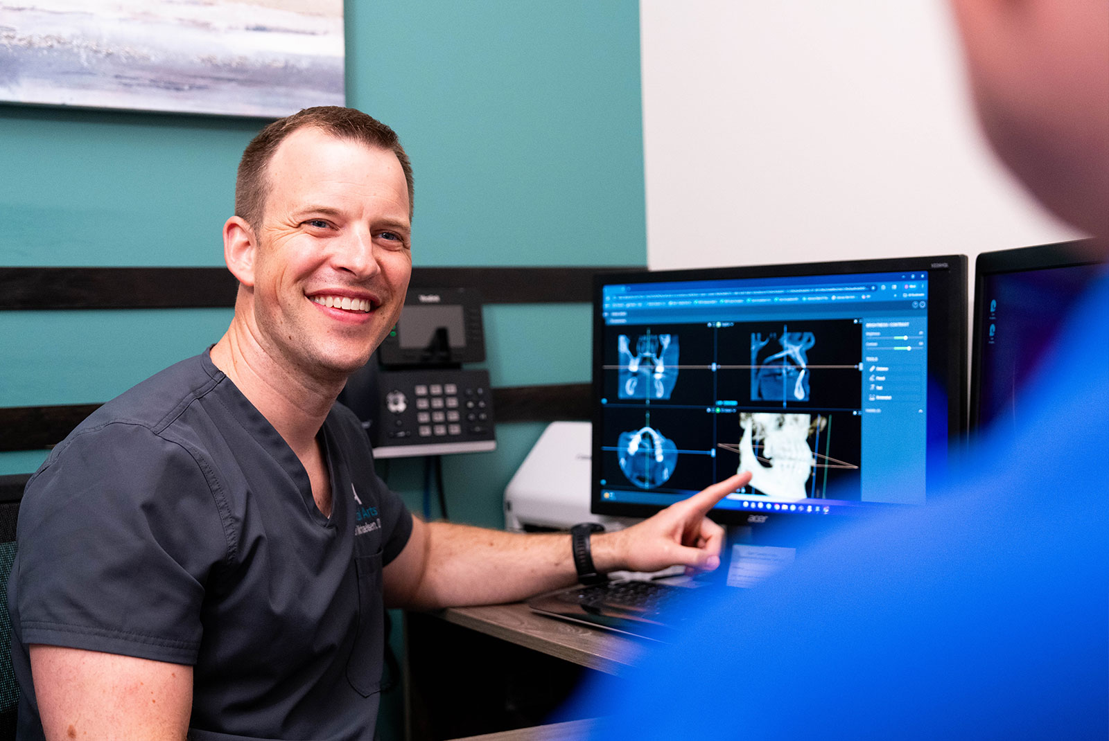 doctor showing patient dental procedure information within the dental center