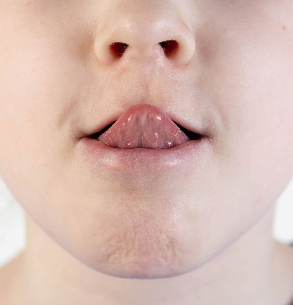 person sticking their tongue close up