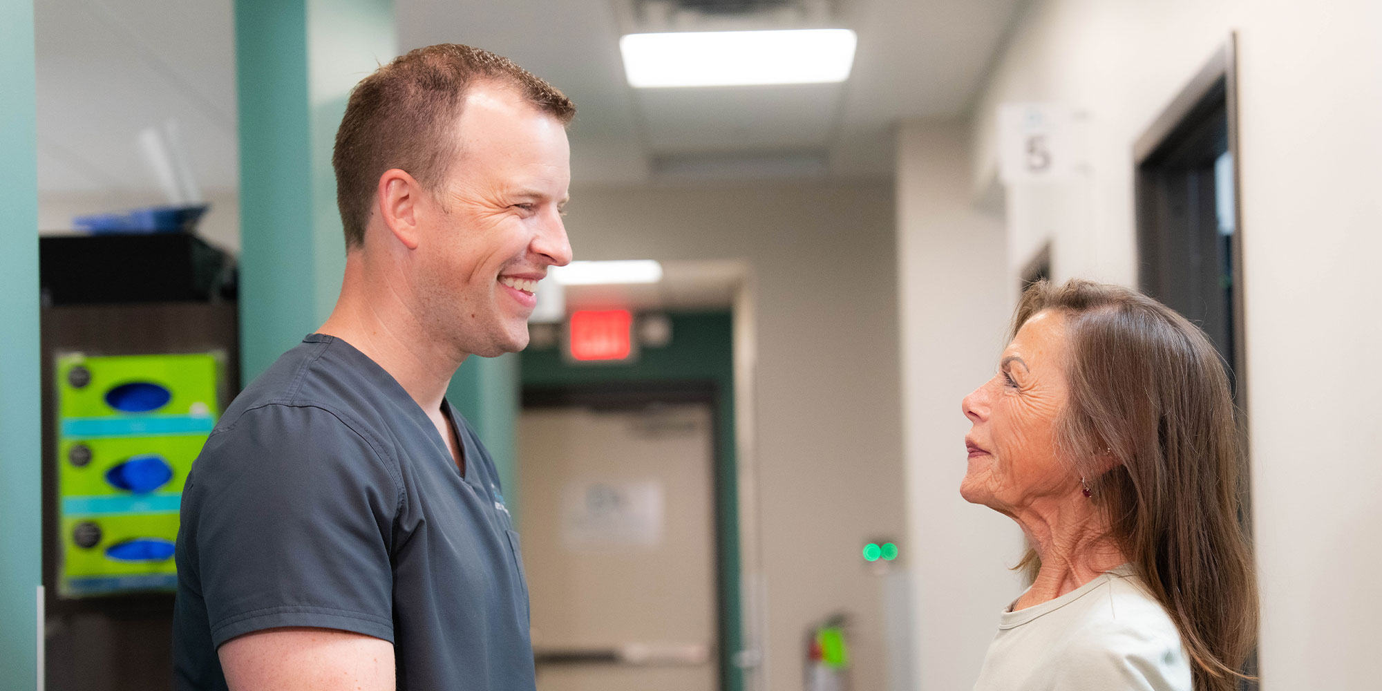 patient and doctor shaking hands and smiling after patient's dental procedure