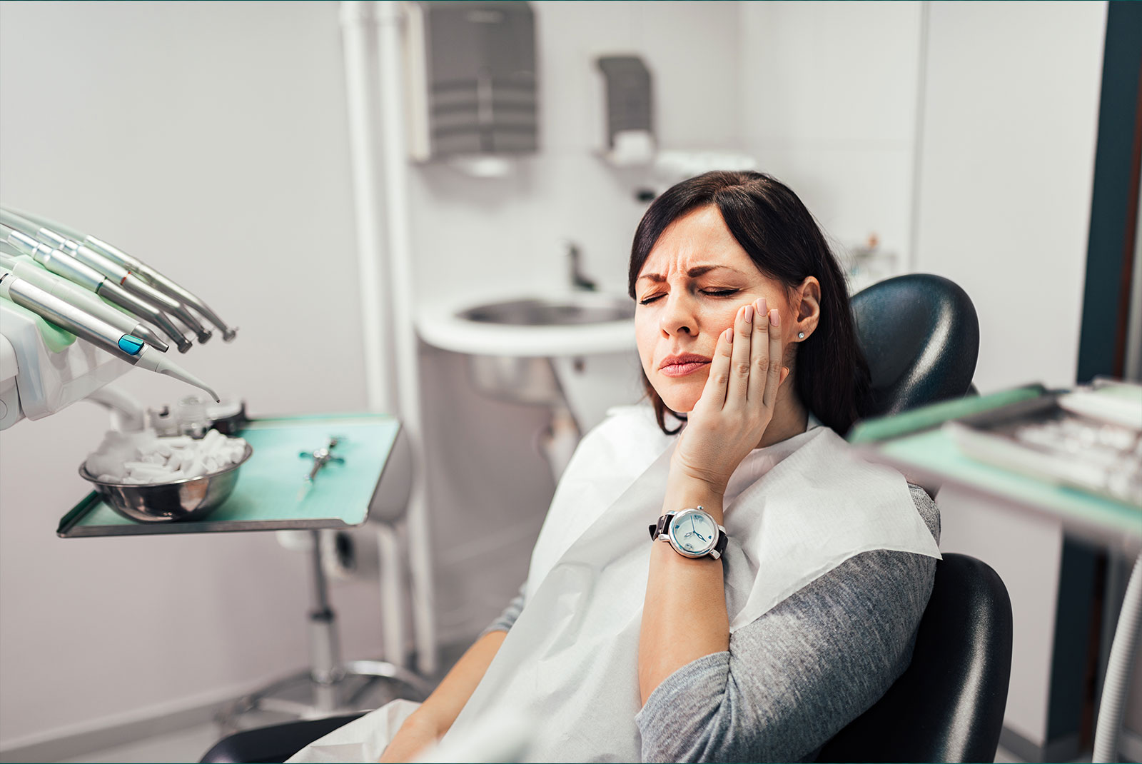 person within the dental center experiencing mouth pain