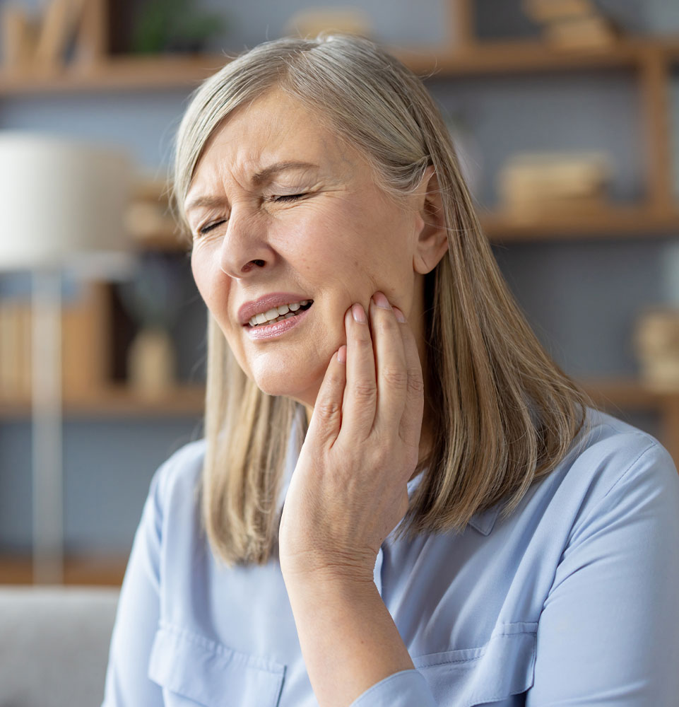 patient experiencing tooth pain within their own home
