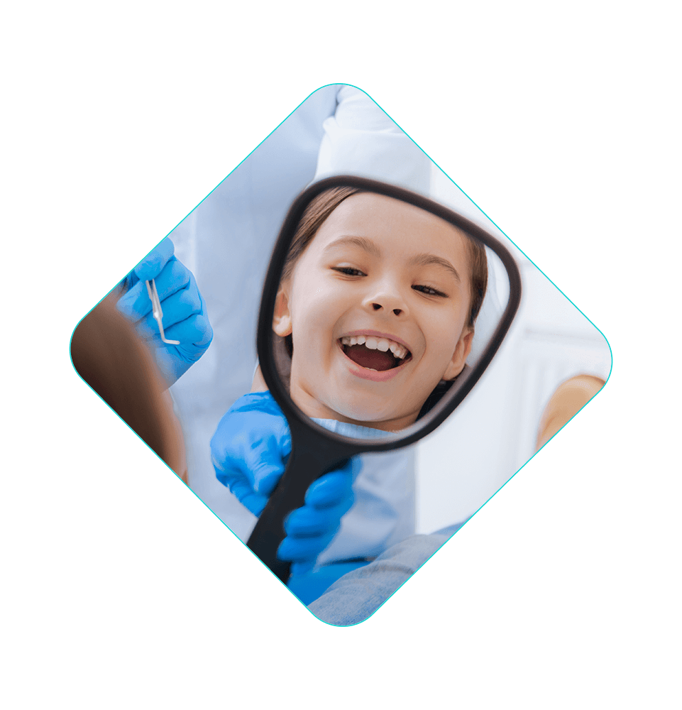 child patient smiling brightly with mouth open within the dental center