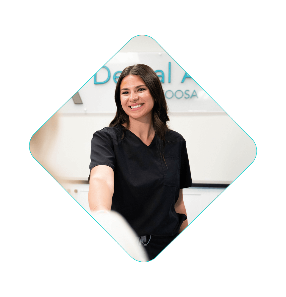 staff member greeting patient at the font desk of the dental center