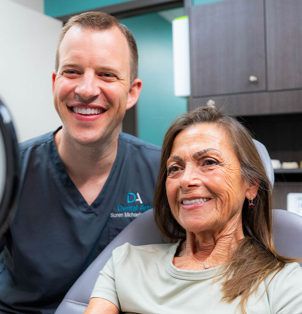doctor and patient smiling brightly after patient's dental procedure