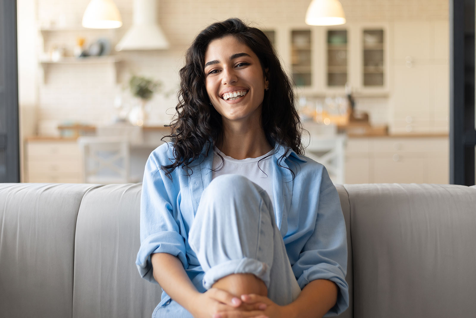 young female smiling brightly in the comfort of their own home