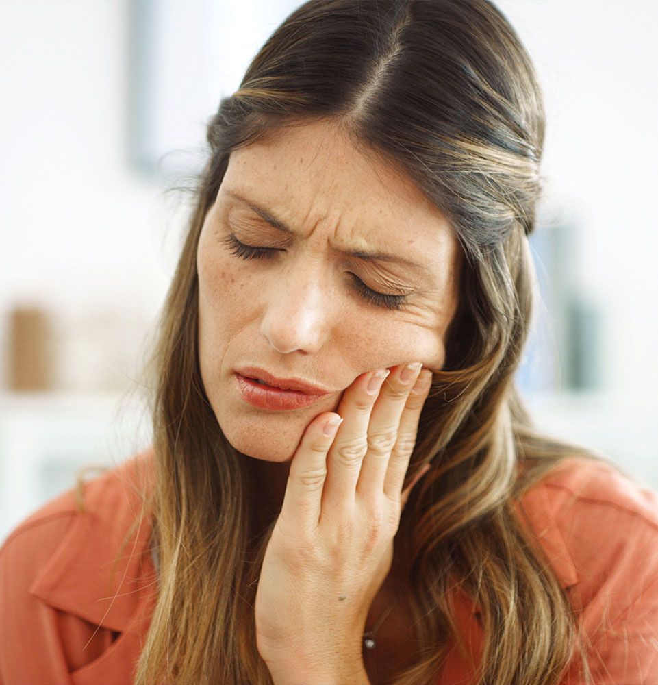 mature female having mouth pain within their own home