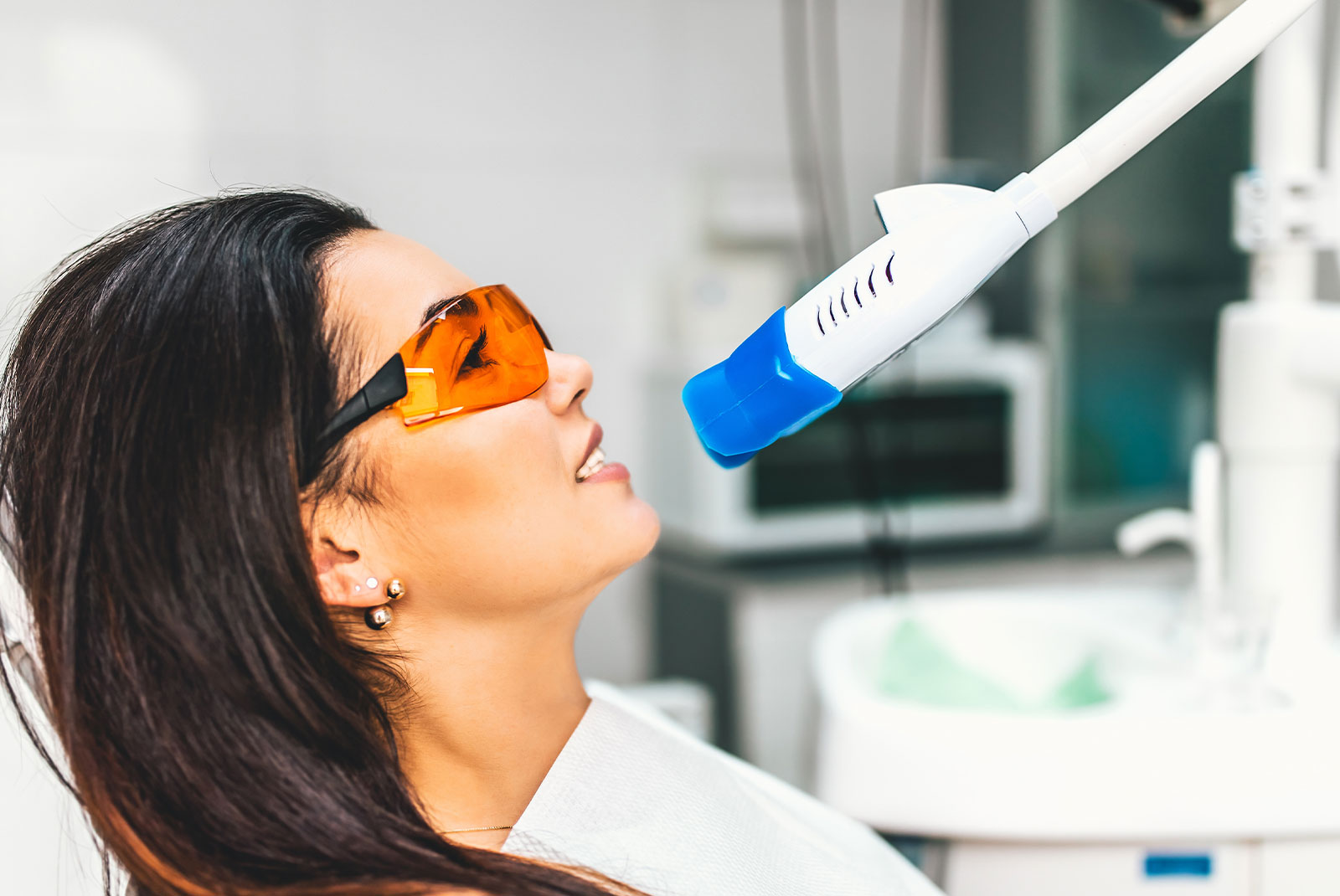 patient having a teeth whitening treatment within the dental center